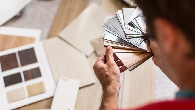 Man choosing from a variety of flooring