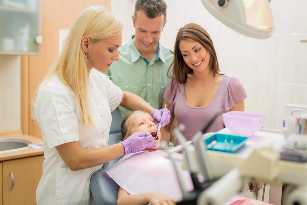 Family on a dentist clinic