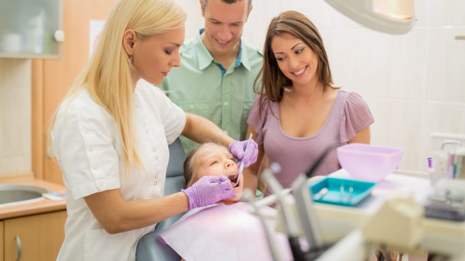 Family on a dentist clinic