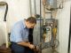 a plumber checking the gas furnace