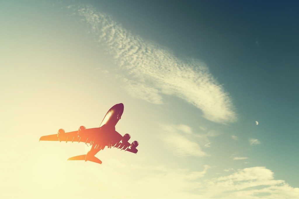 Airplane taking off at sunset