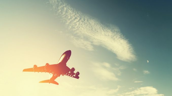 Airplane taking off at sunset