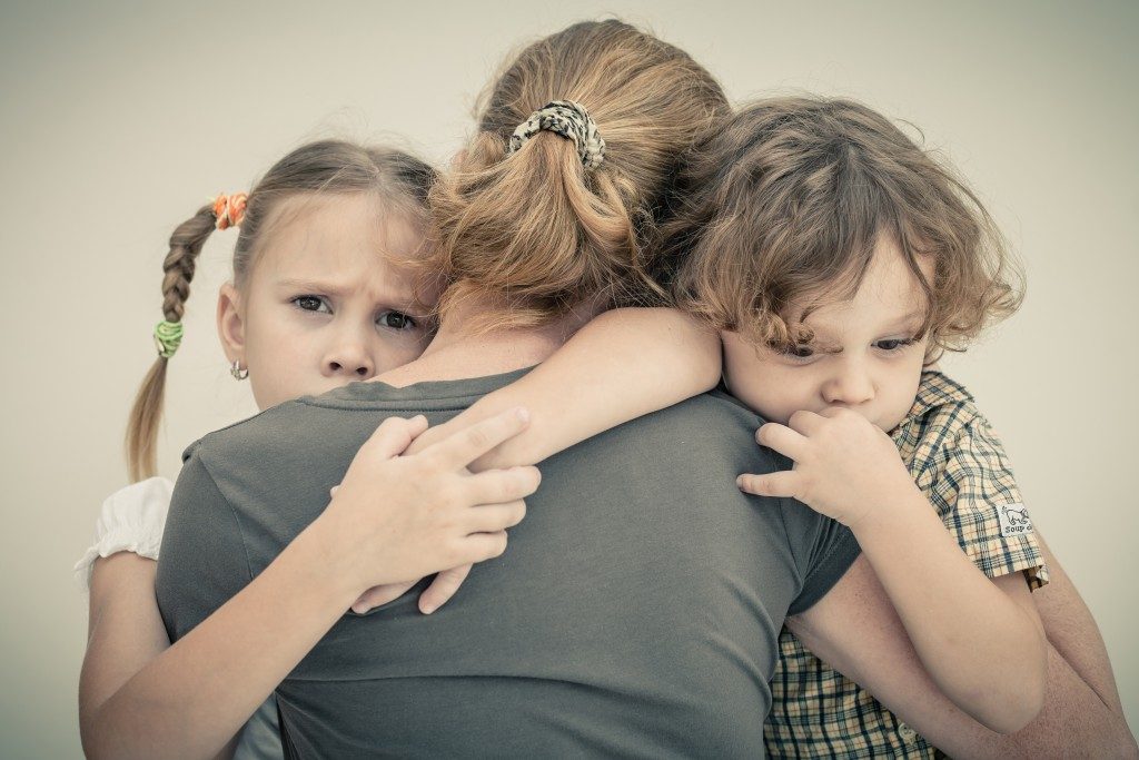 Children hugging their mom