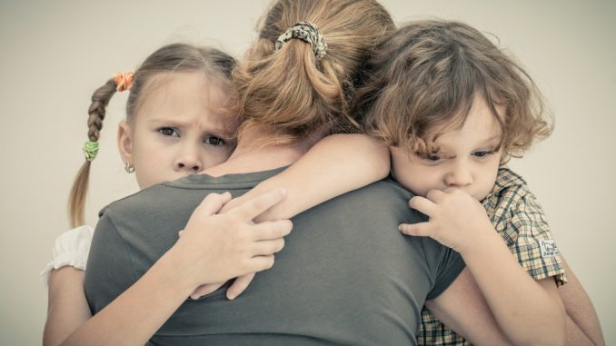 Children hugging their mom