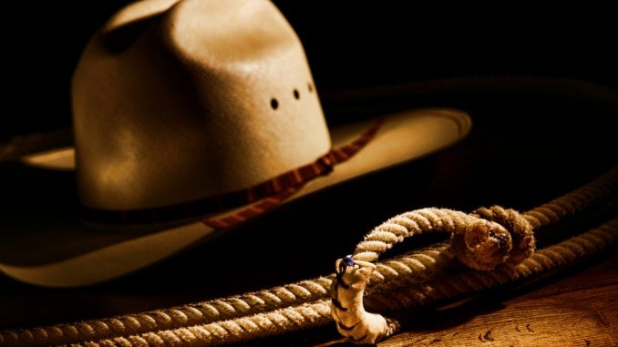 American West rodeo cowboy lasso rope and white straw hat
