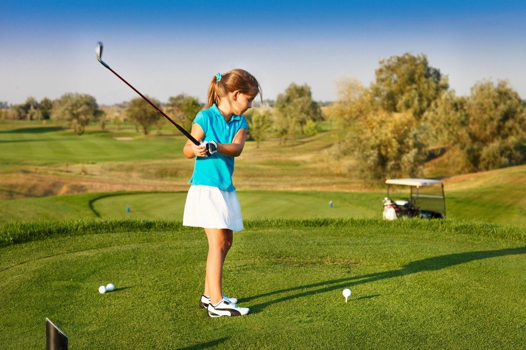 Girl playing golf