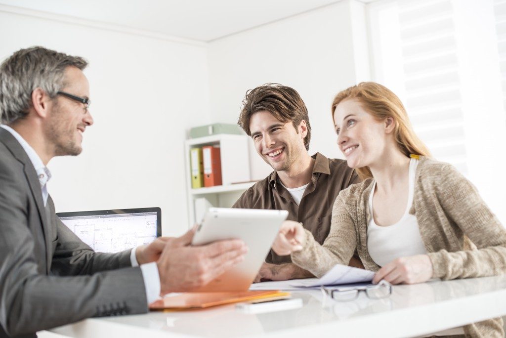 Couple talking to real estate attorney