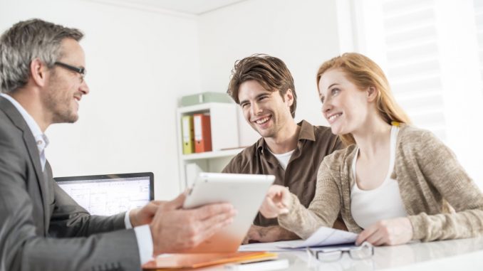 Couple talking to real estate attorney