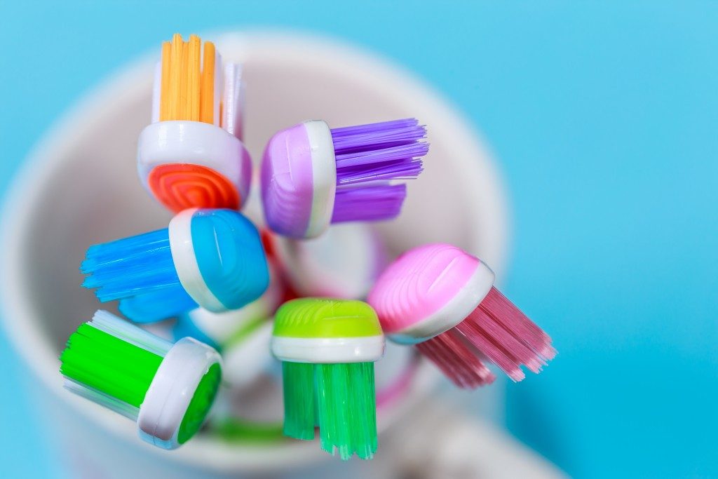 colorful toothbrushes in a mug