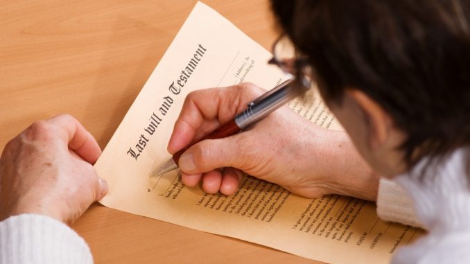 A man signing on his last will document
