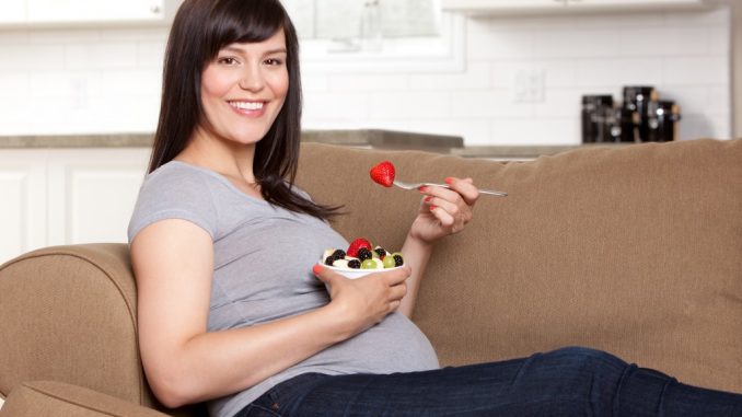 Pregnant Woman Eating Fruits