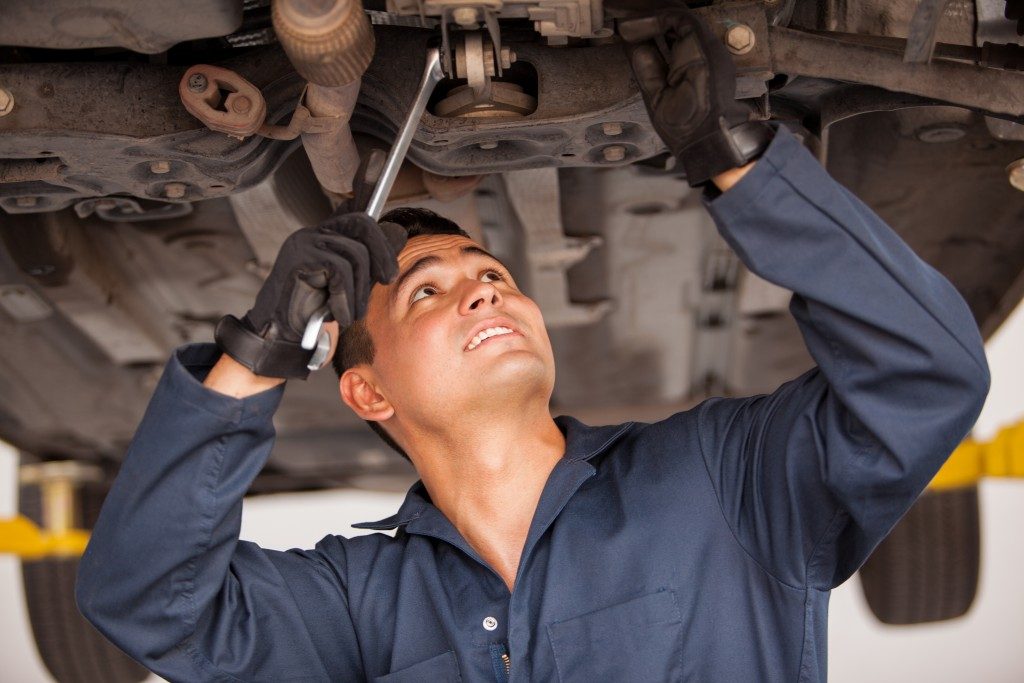 Auto Mechanic Working on a Car