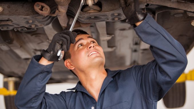 Auto Mechanic Working on a Car