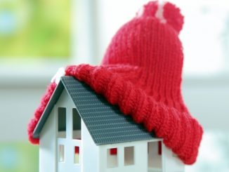 a miniature house with a snow hat
