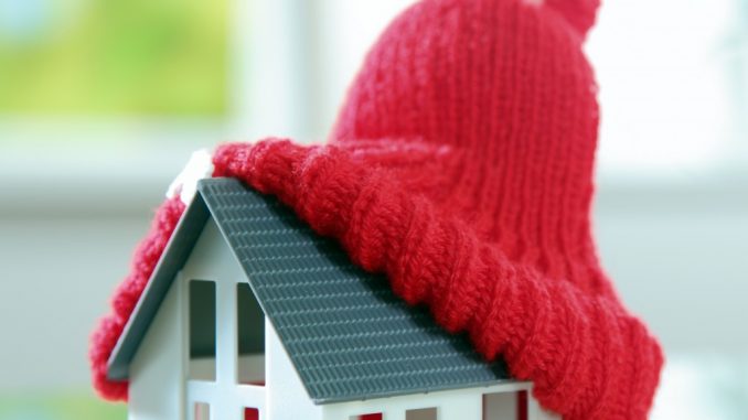 a miniature house with a snow hat