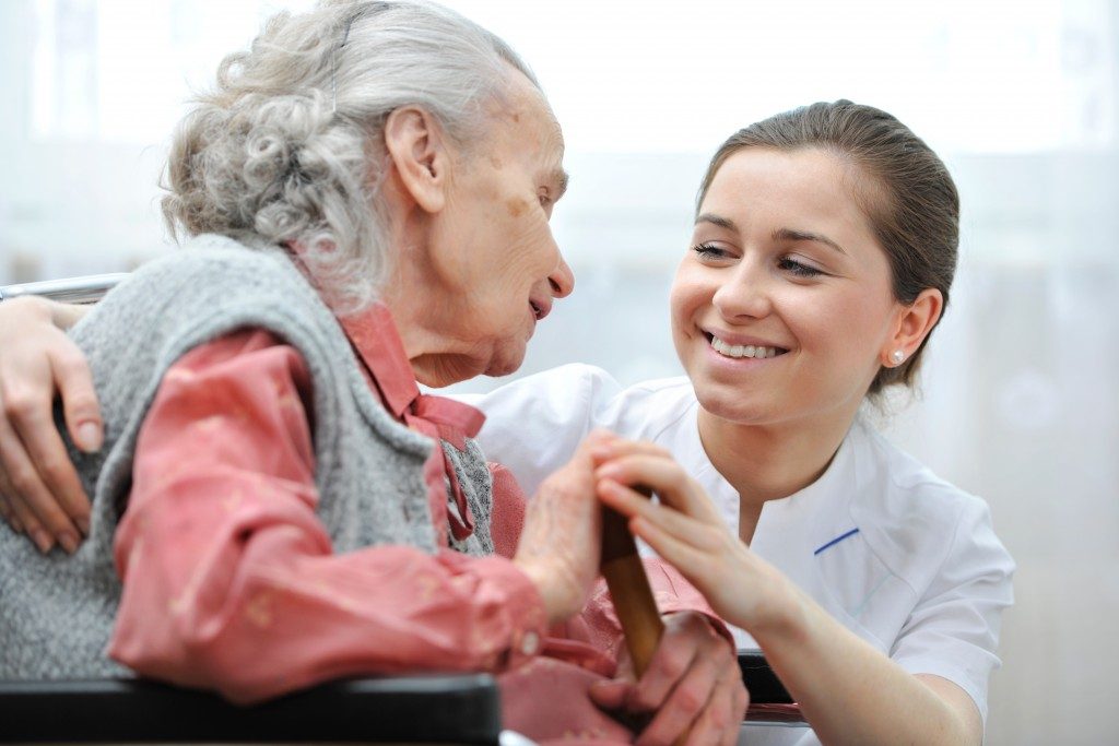 Nurse with disabled elderly woman