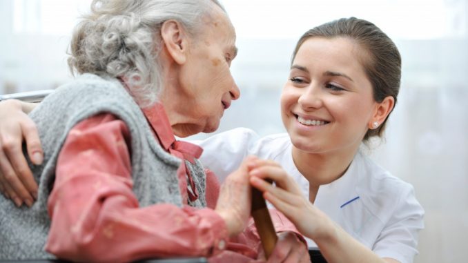 Nurse with disabled elderly woman