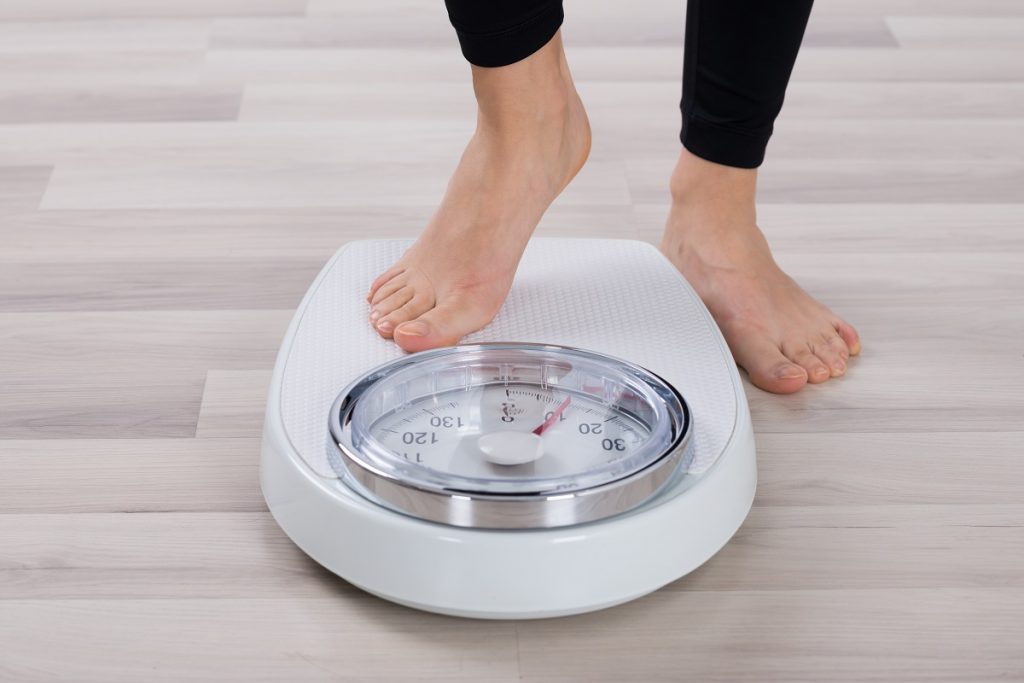 Person about to use a weighing scale