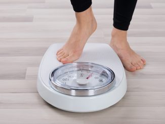 Person about to use a weighing scale