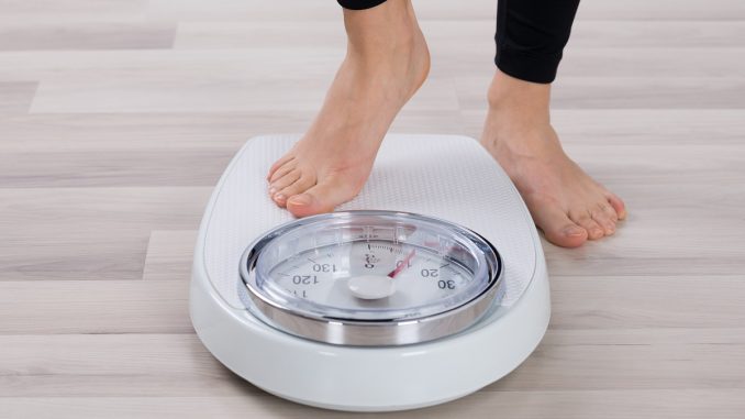 Person about to use a weighing scale