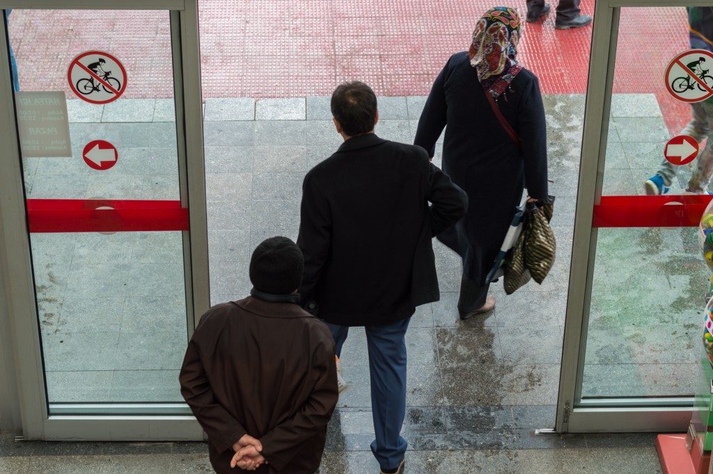 people exiting glass sliding door