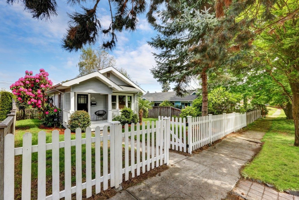 White wooden fence surrounding the house