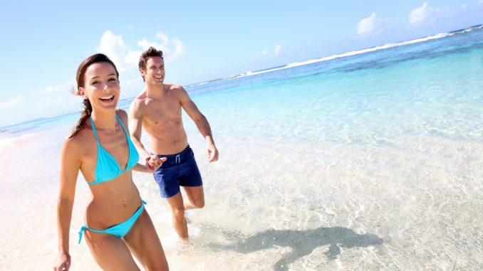 Couple running on a sandy beach