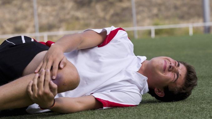 Football player with knee injury