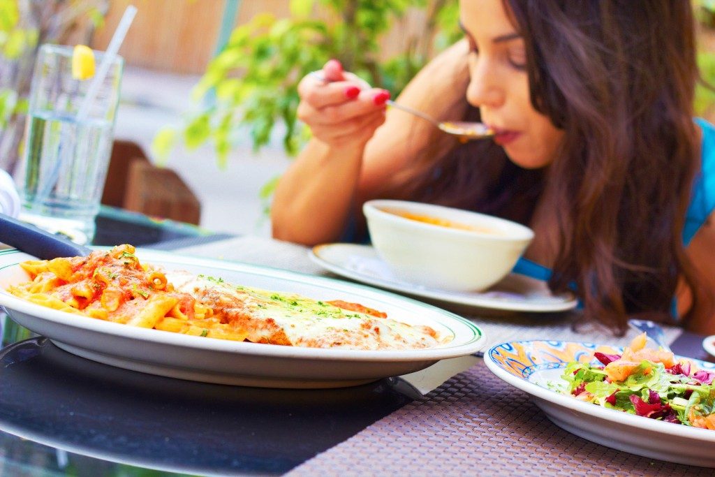 woman eating in an outdoor restaurant