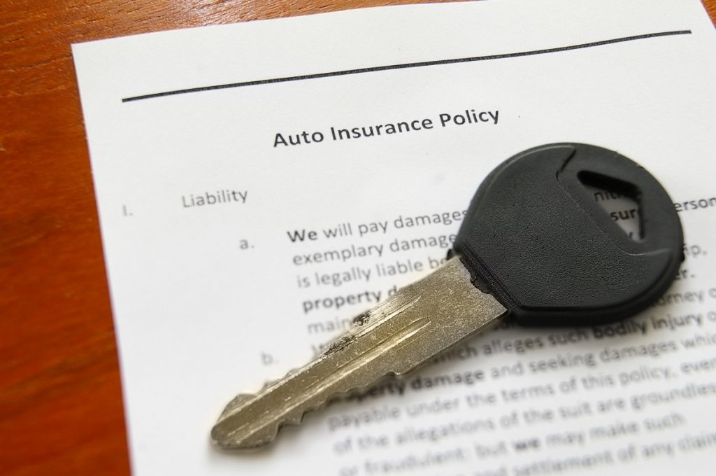a key for an auto on top of an auto insurance policy
