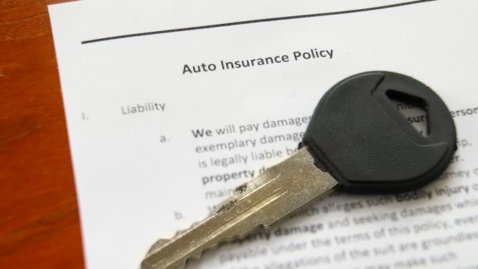 a key for an auto on top of an auto insurance policy