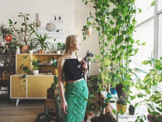 girl standing surrounded by plants