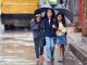 kids sharing an umbrella