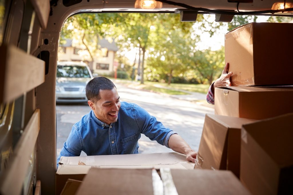 man moving boxes from truck