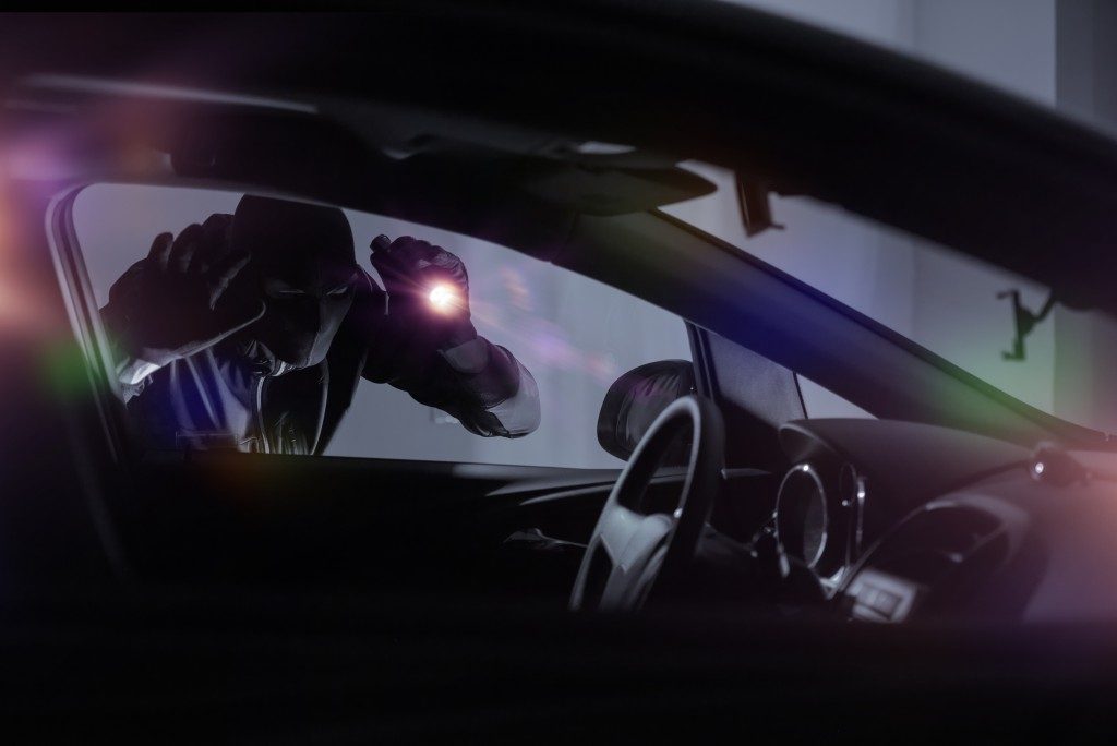 robber shining light inside the car
