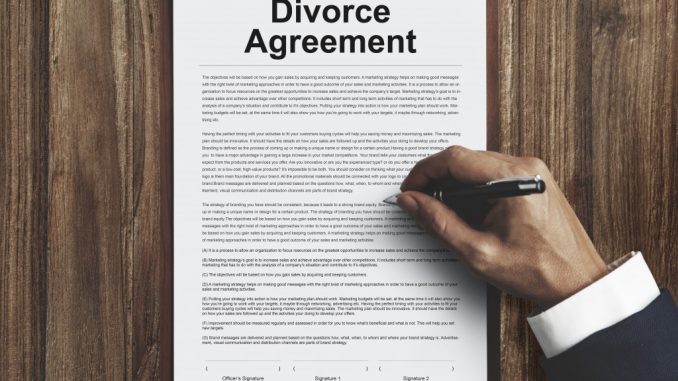 Man signing a divorce agreement