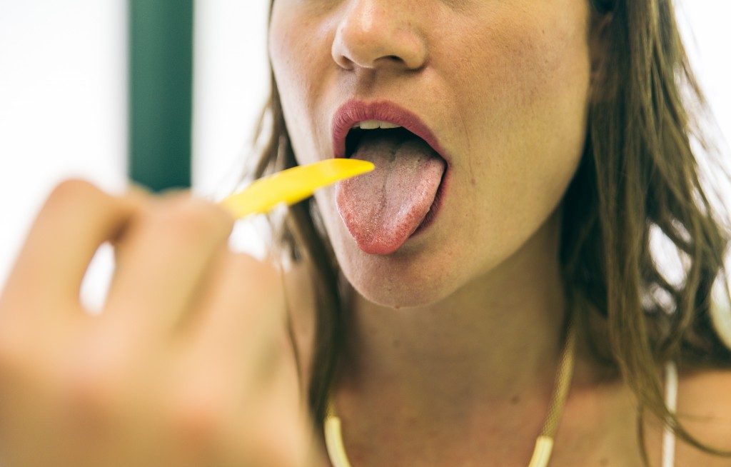 woman having her throat checked