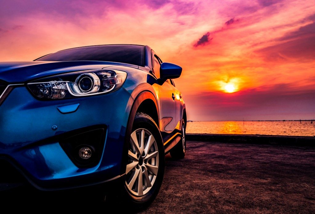 Blue SUV in the sunset