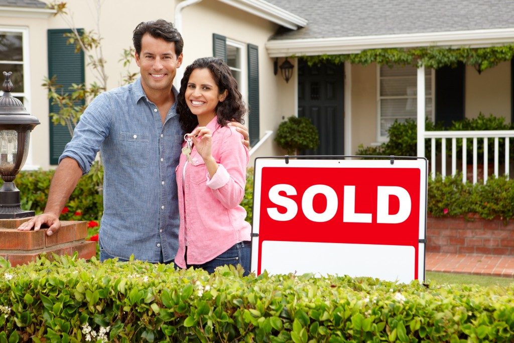couple outside new home