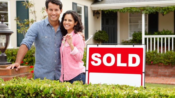 couple outside new home