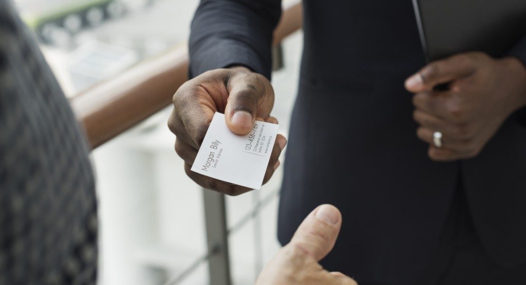 Business man handing over a business card