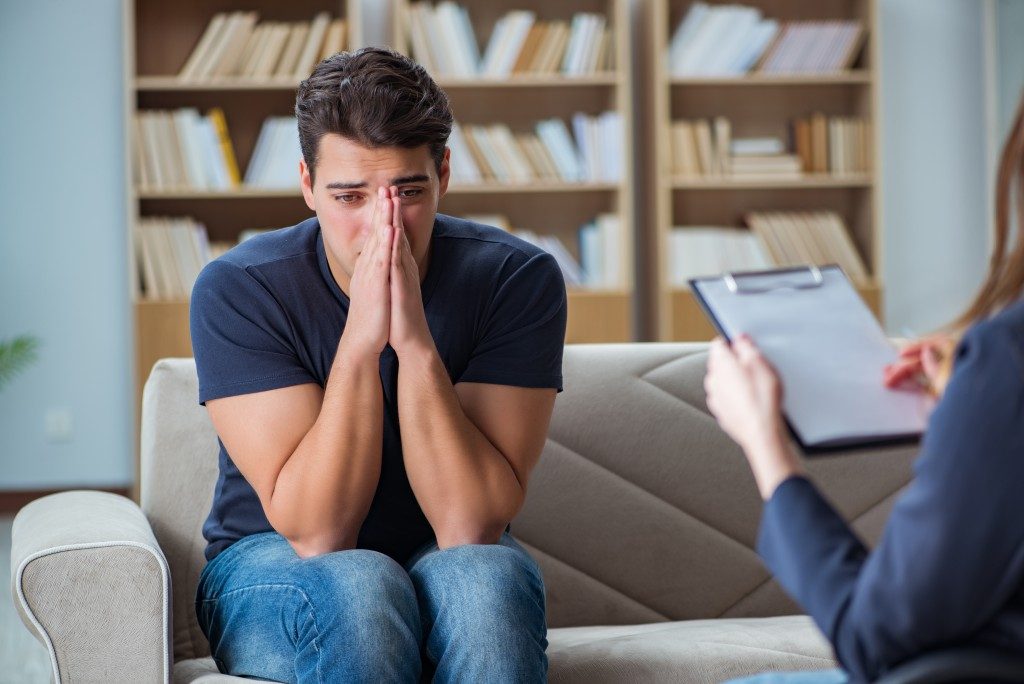 man crying during a therapy session