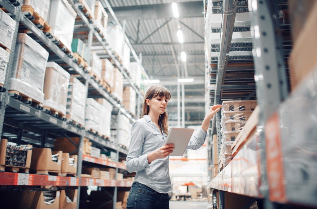 woman checking inventory in the warehouse