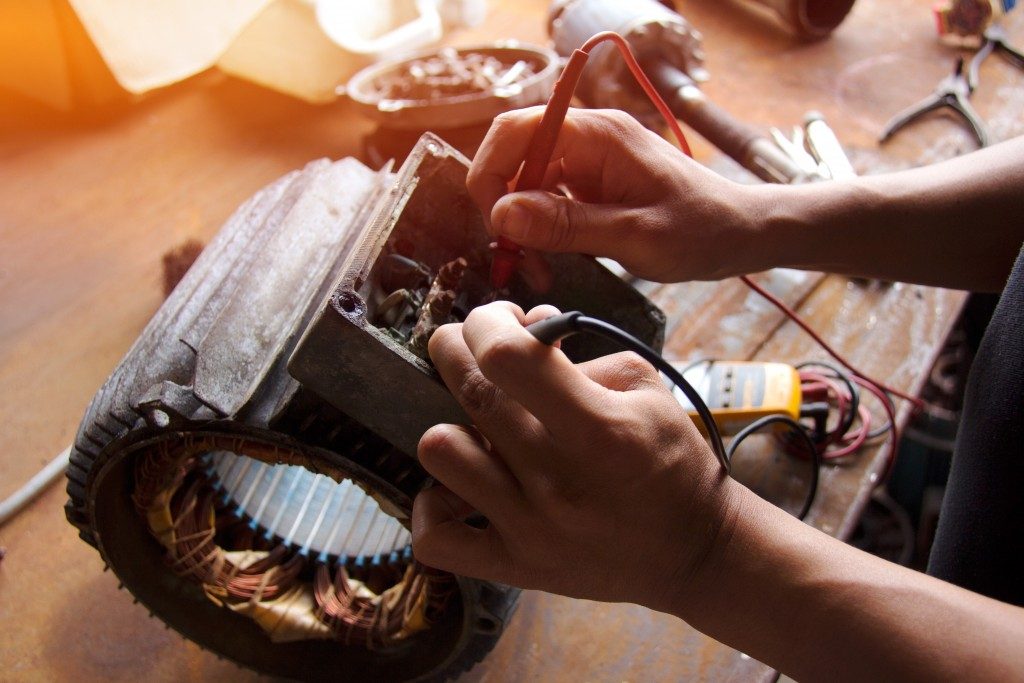 man checking the voltage of an electric motor