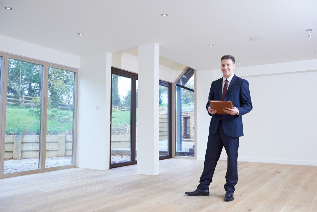 real estate agent inside empty modern house