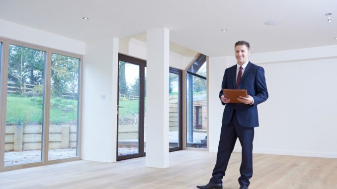 real estate agent inside empty modern house