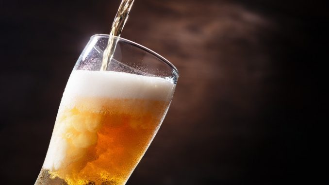 draft beer being poured into a glass