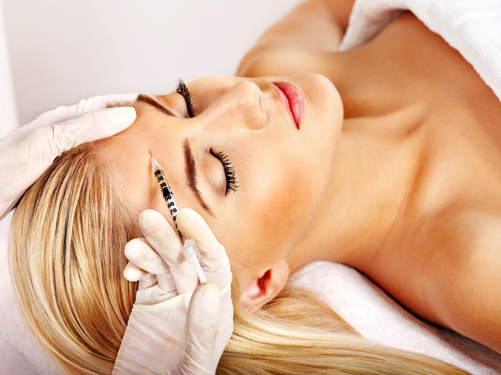 woman with syringe sticking in her forehead