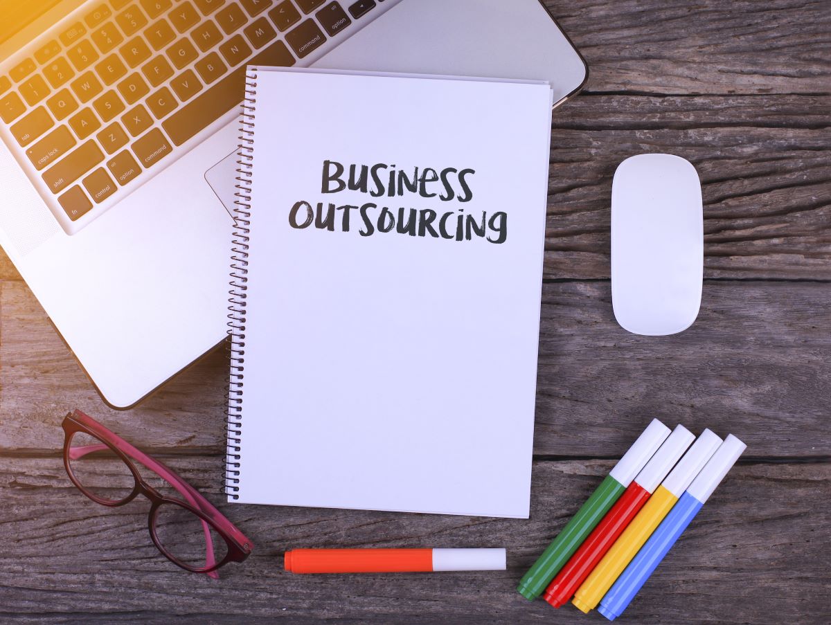 outsourcing written on notebook
