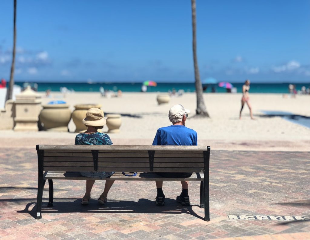 retired couple sitting on a bench